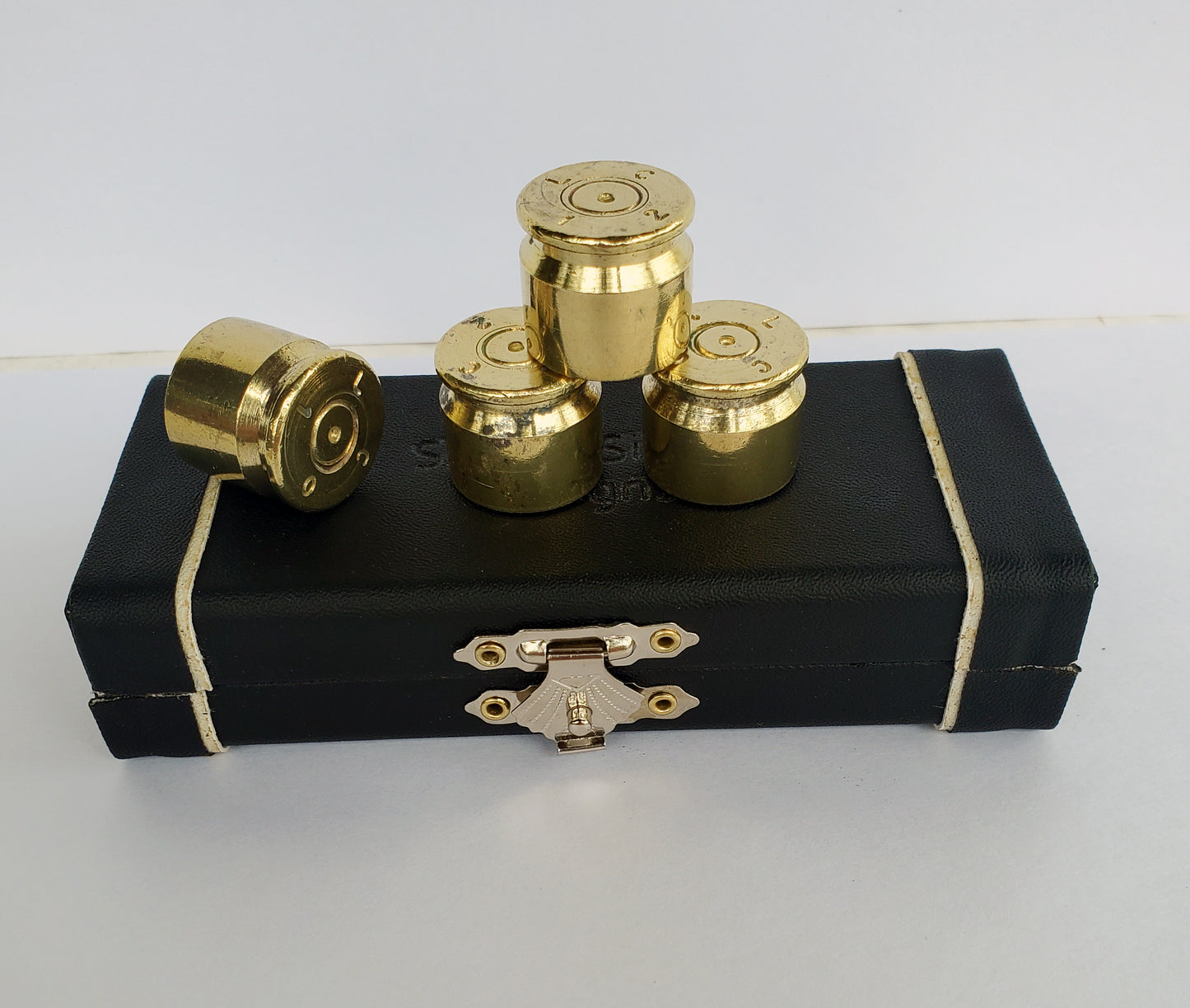 50 Caliber BMG Brass Guitar Knobs on top of case