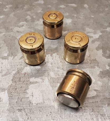 Set of 4 magnets made with recycled 50 Caliber casing on metal sheet